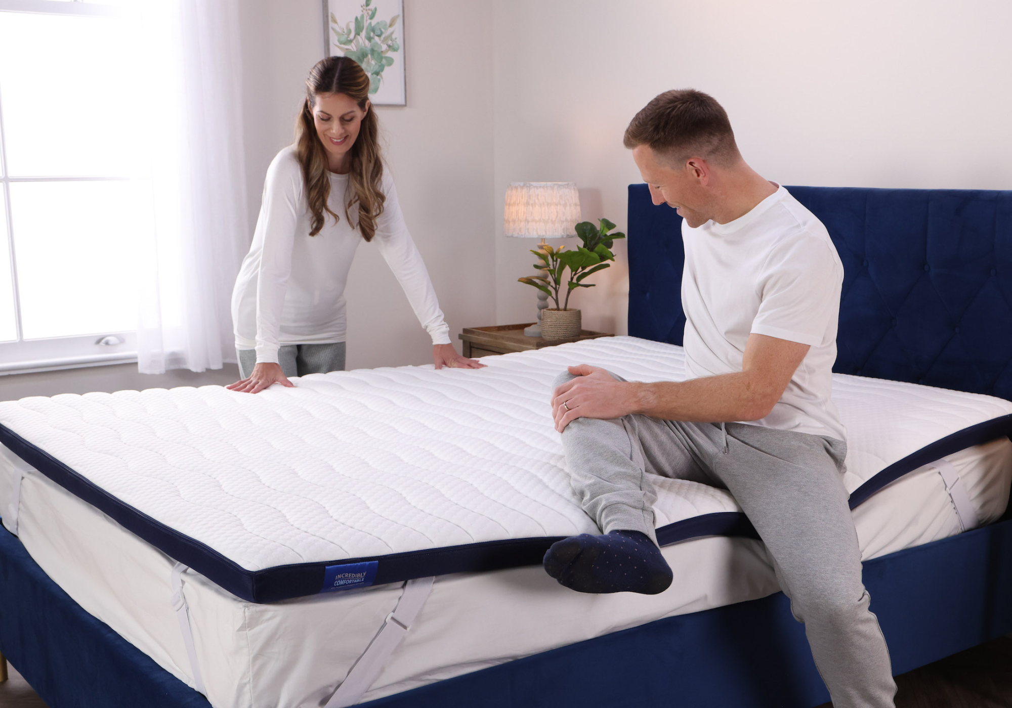 A couple testing out their Seriously Comfortable Revolution Mattress Topper that provides customisable comfort and eliminates 100% of pressure hot spots all encased in a washable, anti bacterial cover