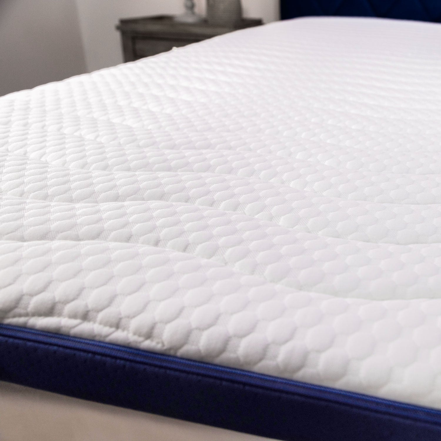 A close up of the Seriously Comfortable Cool Revolution mattress topper white cover