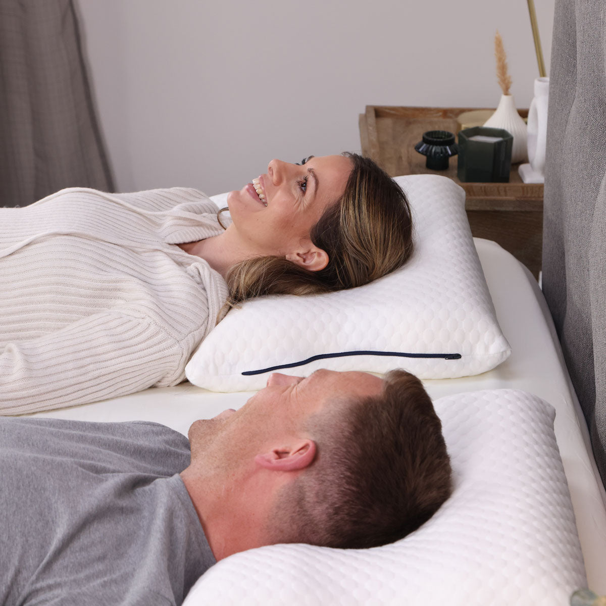 A couple lying on their Seriously Comfortable Ergo Comfort pillows 