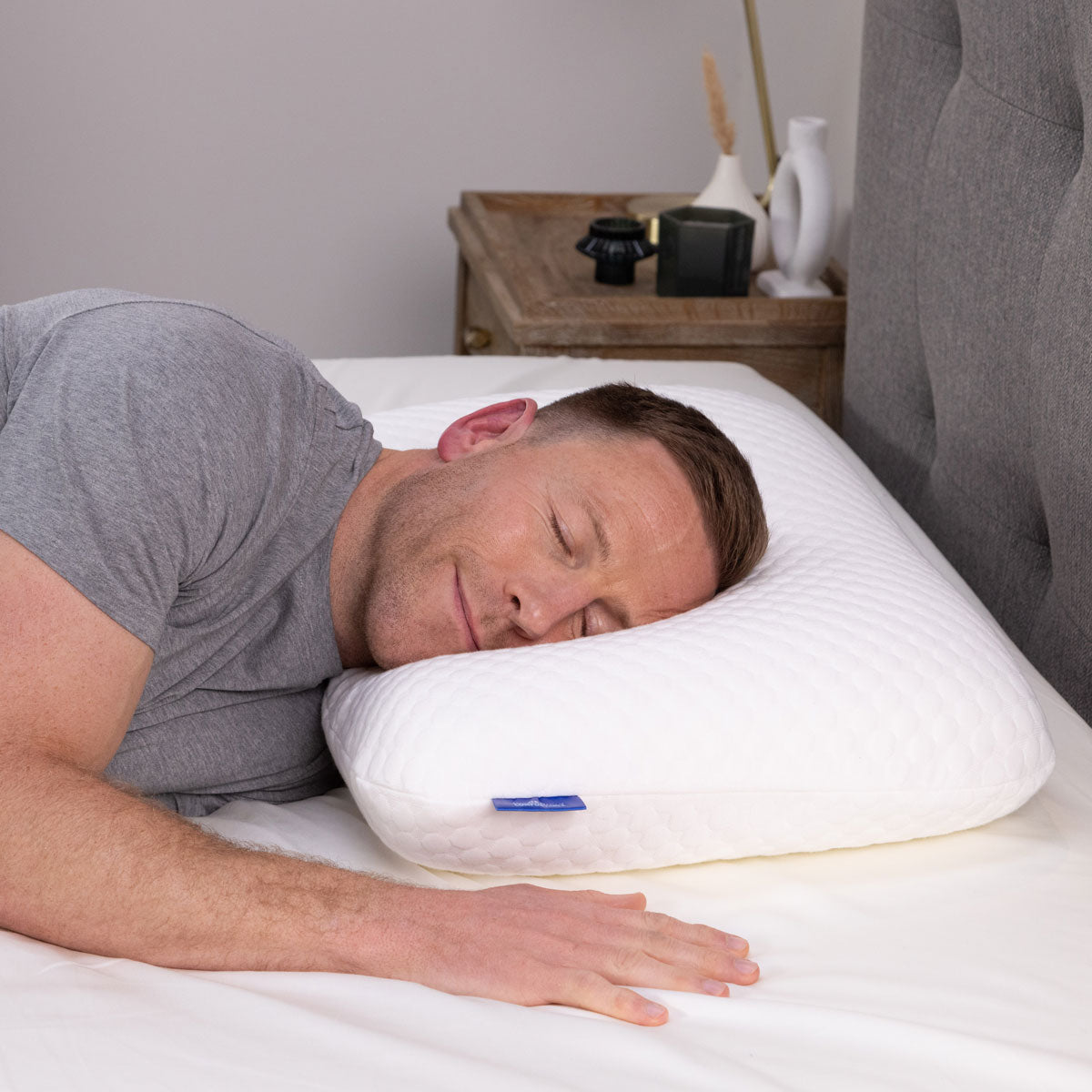 A man lying on his Seriously Comfortable Cool Memory Comfort Compact pillow 